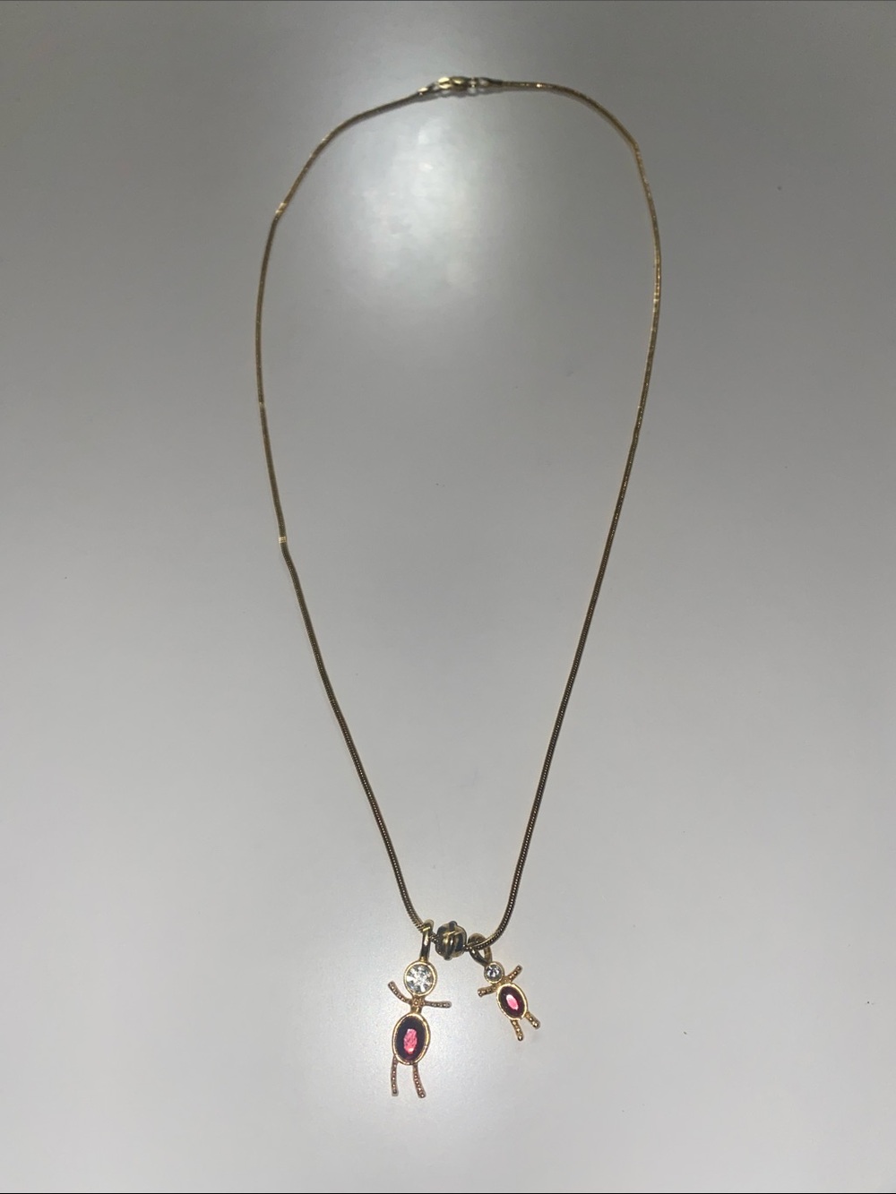 Gold-Tone Necklace with Pink Accent Doll Charms